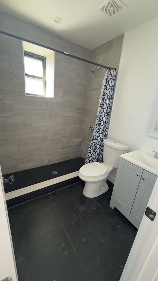 32 Radde Pl, Brooklyn, NY 11233 - bathroom featuring vanity, tiled shower, and tile patterned floors