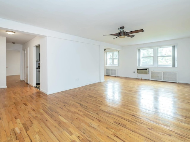 32 Pearsall Ave Unit 3A, Glen Cove, NY 11542 - empty room featuring radiator, ceiling fan, light wood-type flooring, and a wall mounted AC