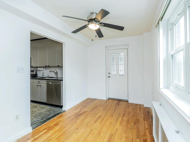 32 Pearsall Ave Unit 3A, Glen Cove, NY 11542 - foyer entrance with hardwood / wood-style floors, a ceiling fan, and baseboards