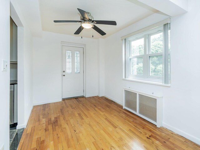32 Pearsall Ave Unit 3A, Glen Cove, NY 11542 - entryway featuring radiator heating unit, plenty of natural light, light wood-type flooring, and ceiling fan