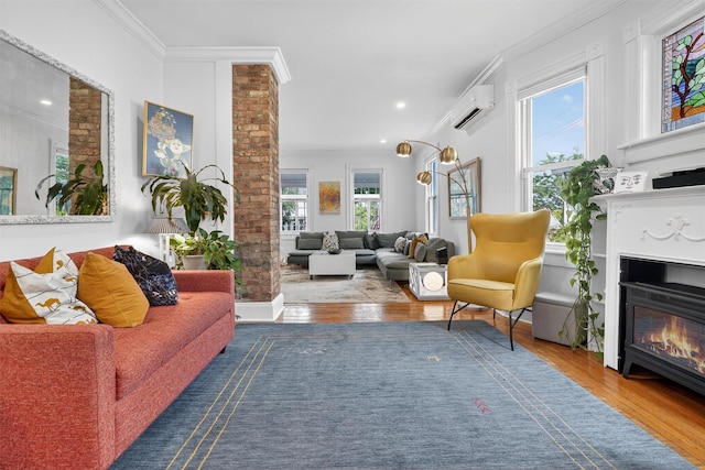 235 Ringgold St, Peekskill, NY 10566 - living room featuring a wall mounted air conditioner, a glass covered fireplace, ornamental molding, wood finished floors, and recessed lighting