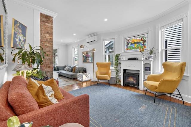 235 Ringgold St, Peekskill, NY 10566 - living area with a wall mounted air conditioner, a glass covered fireplace, wood finished floors, ornamental molding, and recessed lighting