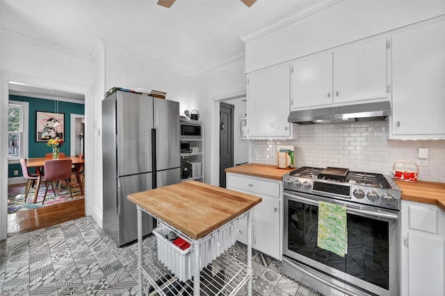 235 Ringgold St, Peekskill, NY 10566 - kitchen featuring appliances with stainless steel finishes, exhaust hood, butcher block countertops, crown molding, and white cabinets