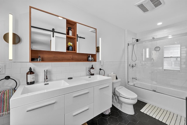 235 Ringgold St, Peekskill, NY 10566 - full bathroom featuring tile walls, double vanity, shower / bath combination with glass door, tile patterned floors, and recessed lighting
