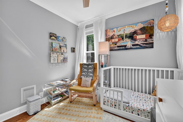 235 Ringgold St, Peekskill, NY 10566 - bedroom featuring ornamental molding, wood finished floors, and ceiling fan