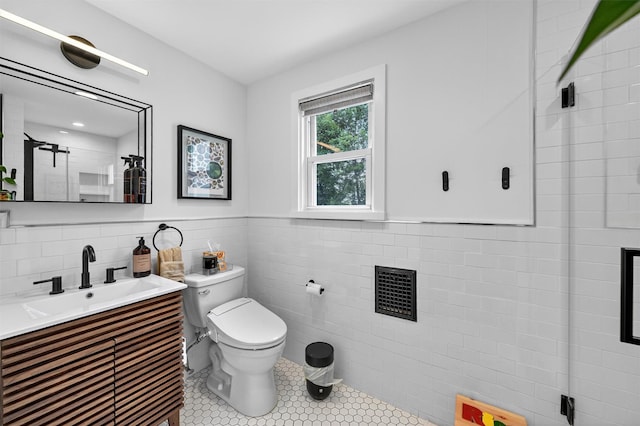 235 Ringgold St, Peekskill, NY 10566 - bathroom with tile walls, vanity, tile patterned floors, a wainscoted wall, and a shower