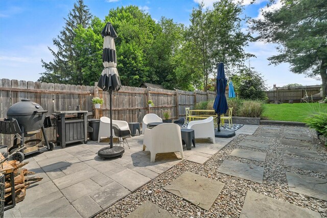 235 Ringgold St, Peekskill, NY 10566 - fenced backyard with a patio area, a grill, and an outdoor fire pit