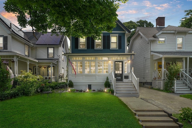235 Ringgold St, Peekskill, NY 10566 - view of front facade with a porch and a lawn