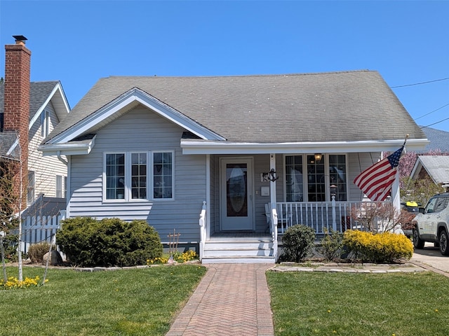 3403 Bay Front Dr, Baldwin, NY 11510 - view of front of home featuring a front lawn and covered porch