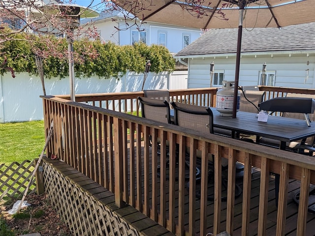 3403 Bay Front Dr, Baldwin, NY 11510 - wooden deck with outdoor dining space and a fenced backyard