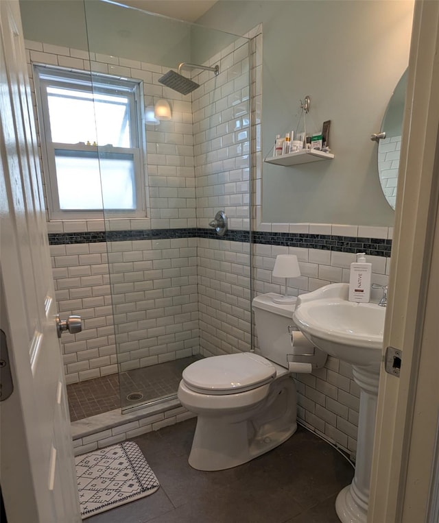 3403 Bay Front Dr, Baldwin, NY 11510 - bathroom featuring toilet, a shower stall, tile patterned floors, tile walls, and wainscoting