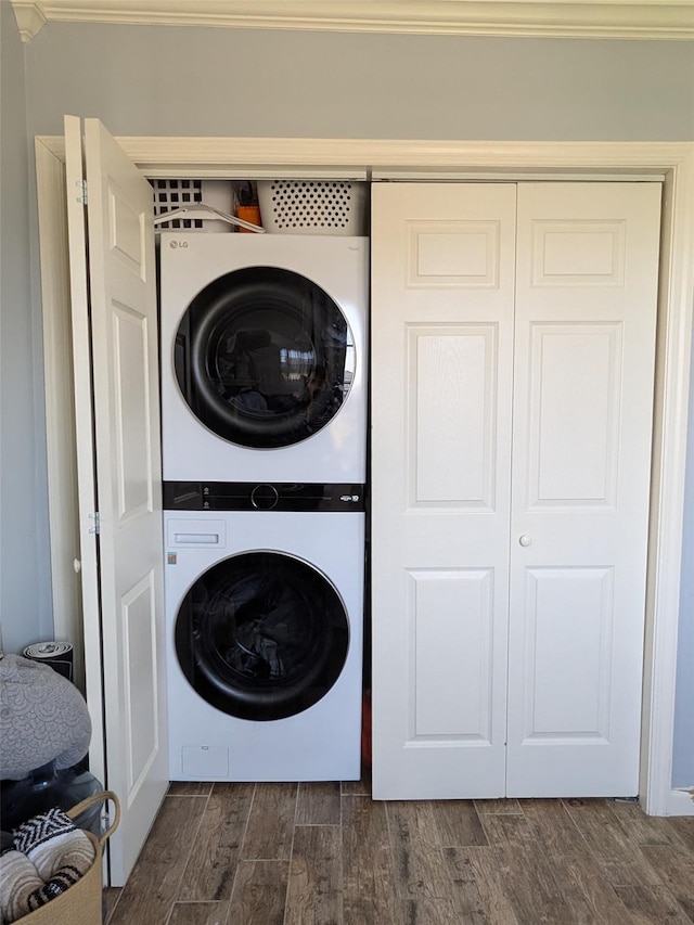 3403 Bay Front Dr, Baldwin, NY 11510 - laundry room featuring stacked washer and clothes dryer and dark wood-style floors