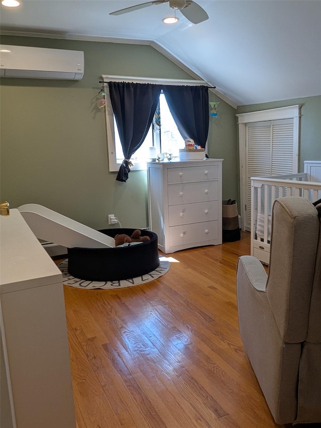 3403 Bay Front Dr, Baldwin, NY 11510 - bedroom featuring a wall mounted AC, vaulted ceiling, wood finished floors, and a ceiling fan