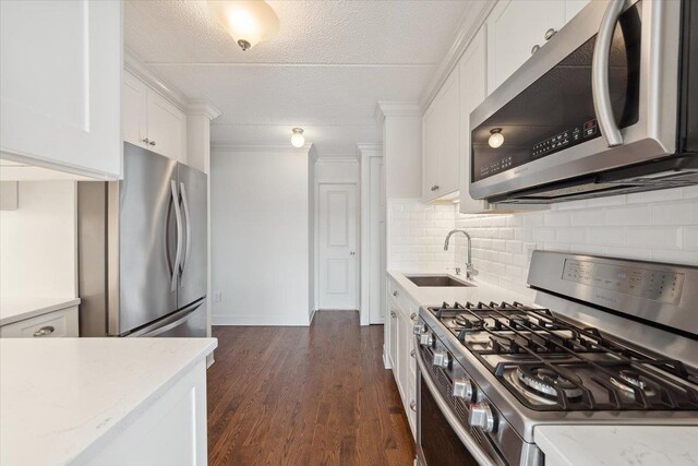 1155 Warburton Ave Unit 12U, Yonkers, NY 10701 - kitchen with appliances with stainless steel finishes, a sink, white cabinetry, backsplash, and dark wood-style flooring