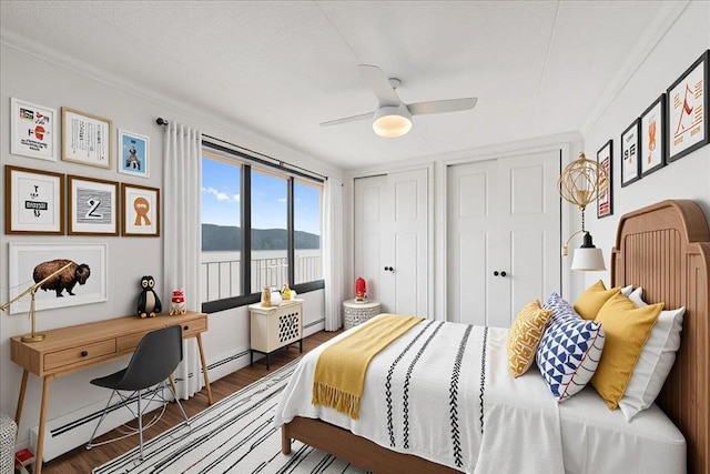 1155 Warburton Ave Unit 12U, Yonkers, NY 10701 - bedroom with wood finished floors, a water view, two closets, ceiling fan, and a baseboard radiator