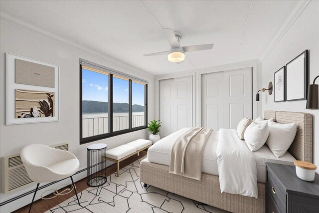 1155 Warburton Ave Unit 12U, Yonkers, NY 10701 - bedroom featuring light wood-type flooring, a baseboard radiator, a water view, two closets, and ceiling fan