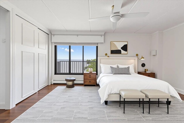 1155 Warburton Ave Unit 12U, Yonkers, NY 10701 - bedroom featuring a baseboard radiator, wood finished floors, ceiling fan, and crown molding