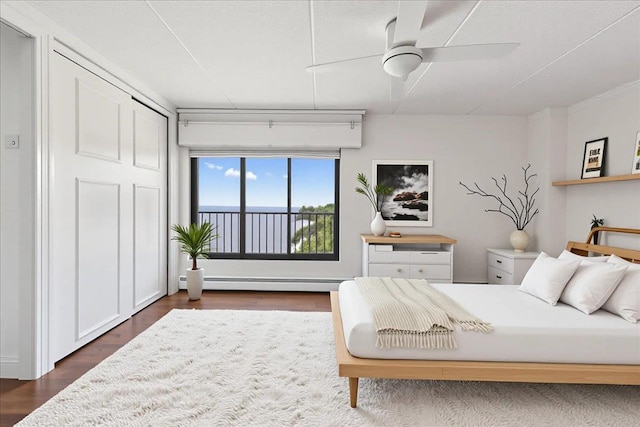 1155 Warburton Ave Unit 12U, Yonkers, NY 10701 - bedroom with dark wood-style floors, a baseboard radiator, and a ceiling fan