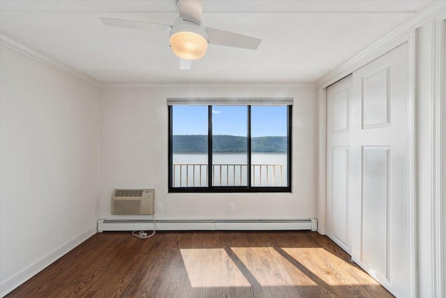 1155 Warburton Ave Unit 12U, Yonkers, NY 10701 - unfurnished bedroom featuring ornamental molding, wood finished floors, a baseboard radiator, a wall mounted AC, and baseboards