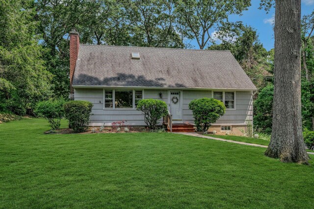 39 Dartmouth Rd, Shoreham, NY 11786 - view of front of home with a front lawn, a chimney, and a shingled roof