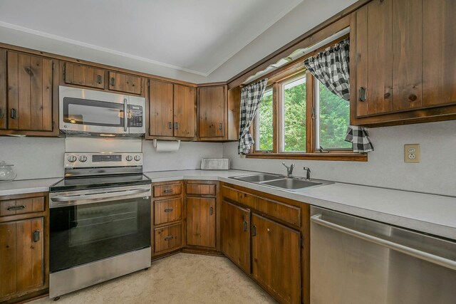 39 Dartmouth Rd, Shoreham, NY 11786 - kitchen with appliances with stainless steel finishes, light countertops, a sink, and brown cabinets