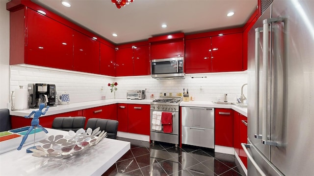 2955 Ocean Pkwy Unit 2F, Brooklyn, NY 11235 - kitchen featuring red cabinetry, high quality appliances, granite tiled floors, tasteful backsplash, and recessed lighting