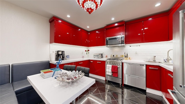 2955 Ocean Pkwy Unit 2F, Brooklyn, NY 11235 - kitchen featuring red cabinets, appliances with stainless steel finishes, granite floors, recessed lighting, and tasteful backsplash