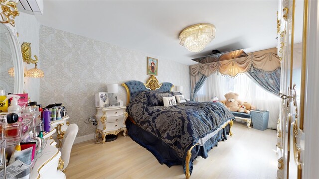 2955 Ocean Pkwy Unit 2F, Brooklyn, NY 11235 - bedroom with wallpapered walls, wood finished floors, a wall mounted AC, and a chandelier