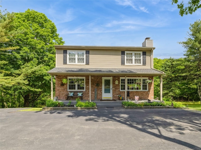1760 Rte 199, Stanfordville, NY 12581 - traditional-style house with covered porch, a chimney, and brick siding