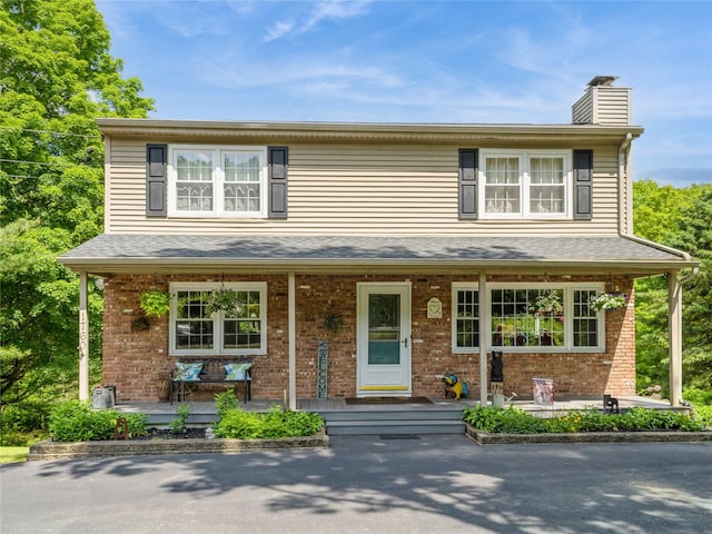 1760 Rte 199, Stanfordville, NY 12581 - view of front facade featuring a porch, a chimney, and brick siding