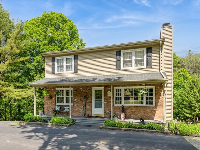 1760 Rte 199, Stanfordville, NY 12581 - traditional-style home with a porch, brick siding, and a chimney