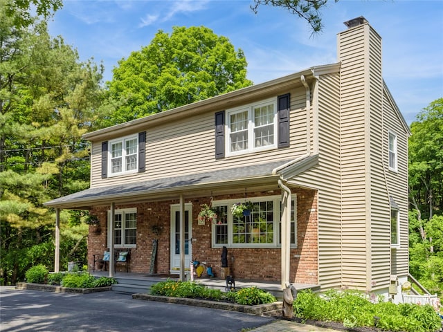 1760 Rte 199, Stanfordville, NY 12581 - view of front facade with a porch, brick siding, and a chimney