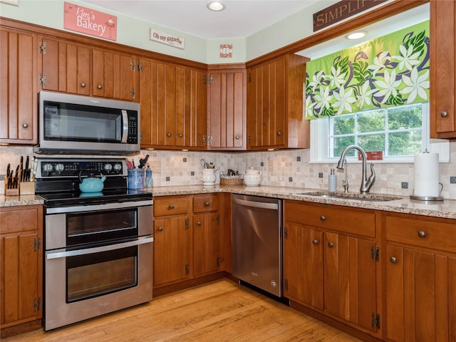 1760 Rte 199, Stanfordville, NY 12581 - kitchen with appliances with stainless steel finishes, a sink, brown cabinets, and backsplash