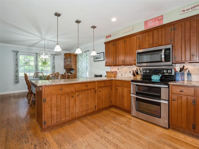 1760 Rte 199, Stanfordville, NY 12581 - kitchen featuring appliances with stainless steel finishes, a peninsula, brown cabinetry, ornamental molding, and tasteful backsplash