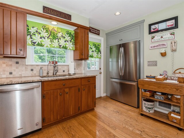 1760 Rte 199, Stanfordville, NY 12581 - kitchen featuring stainless steel appliances, a sink, light wood-type flooring, backsplash, and light stone countertops