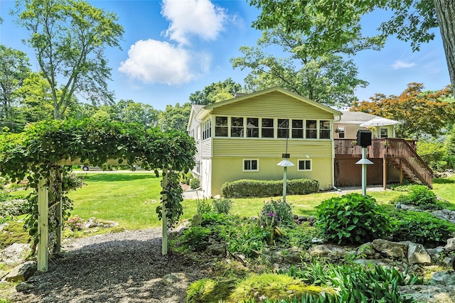 69 Clove Brook Dr, Cold Spring, NY 10516 - back of property with stairs, a wooden deck, a yard, and a sunroom