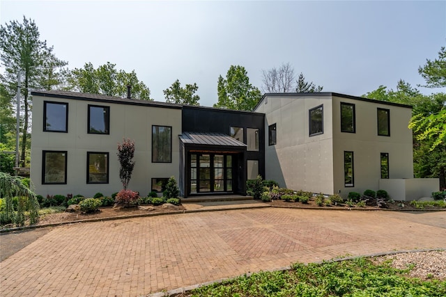 26 Windemere Way, Woodbury, NY 11797 - modern home featuring stucco siding
