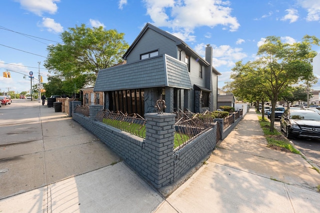 14428 Farmers Blvd, Rochdale, NY 11434 - multi unit property featuring a fenced front yard and a chimney