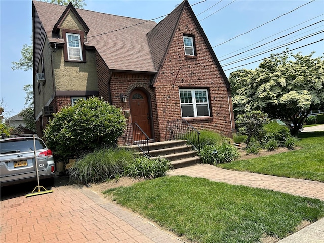 9 Troy Pl, Merrick, NY 11566 - english style home with roof with shingles, brick siding, and a front lawn