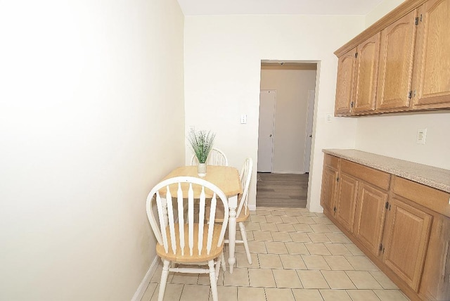 16 Main St Unit 3K, East Rockaway, NY 11518 - kitchen with light countertops, baseboards, and light tile patterned flooring