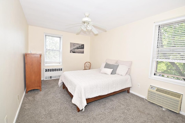 16 Main St Unit 3K, East Rockaway, NY 11518 - bedroom with radiator, multiple windows, a wall mounted air conditioner, and baseboards