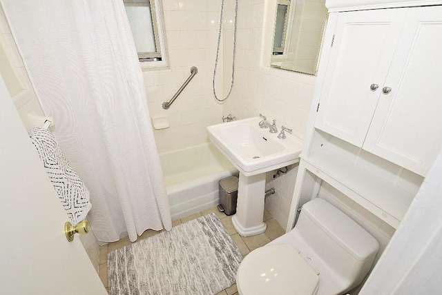 16 Main St Unit 3K, East Rockaway, NY 11518 - bathroom with shower / tub combo, toilet, and tile walls