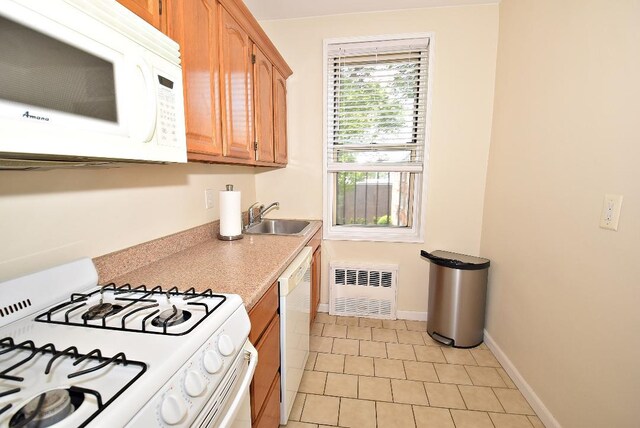 16 Main St Unit 3K, East Rockaway, NY 11518 - kitchen featuring white appliances, a sink, light countertops, light tile patterned floors, and baseboards