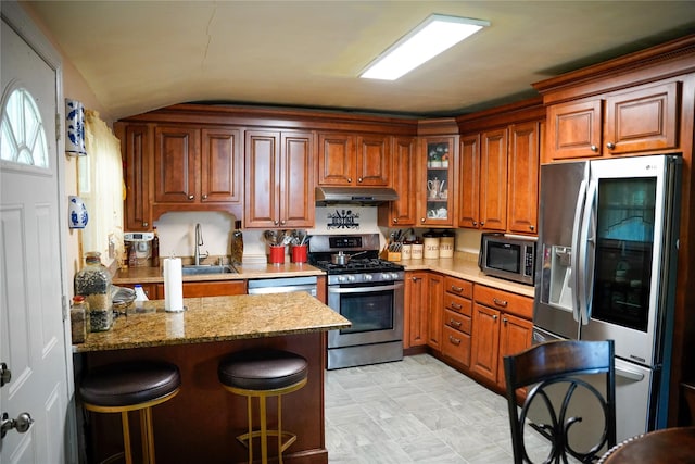 188 N Middletown Rd, Nanuet, NY 10954 - kitchen with appliances with stainless steel finishes, a sink, under cabinet range hood, a peninsula, and brown cabinets