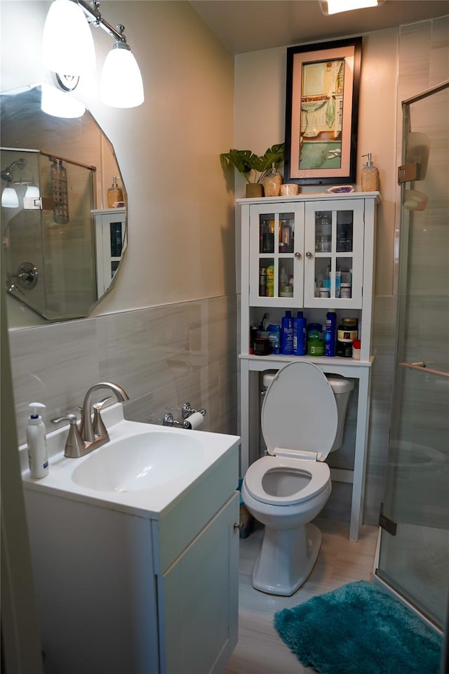 188 N Middletown Rd, Nanuet, NY 10954 - bathroom with tile walls, vanity, a stall shower, toilet, and wainscoting