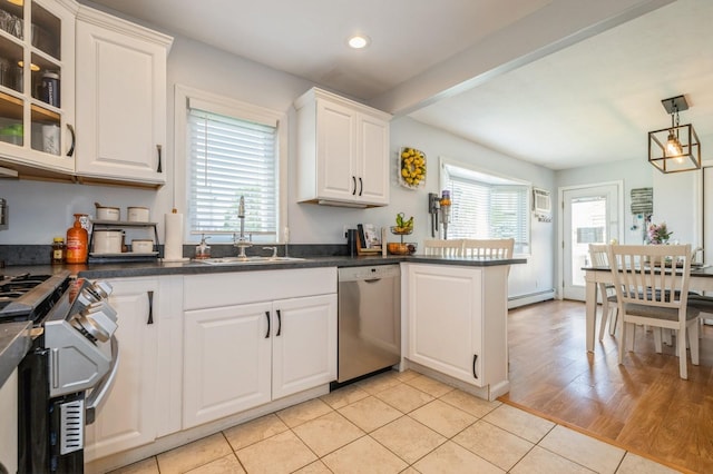 203 E Shore Rd, Lindenhurst, NY 11757 - kitchen with stainless steel appliances, a sink, recessed lighting, white cabinetry, and dark countertops