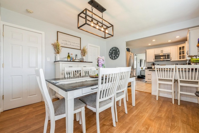 203 E Shore Rd, Lindenhurst, NY 11757 - dining room with light wood-style floors, recessed lighting, and a chandelier