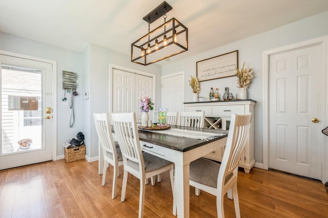203 E Shore Rd, Lindenhurst, NY 11757 - dining area featuring light wood-style floors, baseboards, and a chandelier