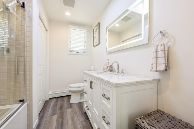 203 E Shore Rd, Lindenhurst, NY 11757 - full bath featuring a baseboard radiator, vanity, toilet, wood finished floors, and recessed lighting