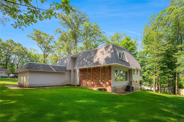 34 Winesap Ln, Monsey, NY 10952 - rear view of property with central air condition unit, a lawn, roof with shingles, and mansard roof